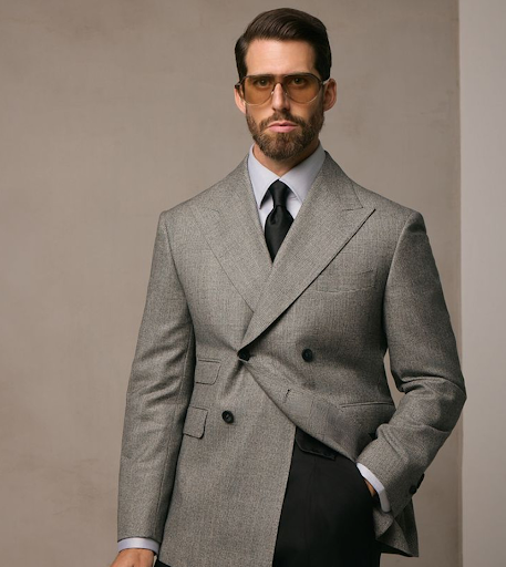 Man wearing a grey double-breasted bespoke suit in a Prince of Wales check with peak lapels, light blue shirt, and black tie